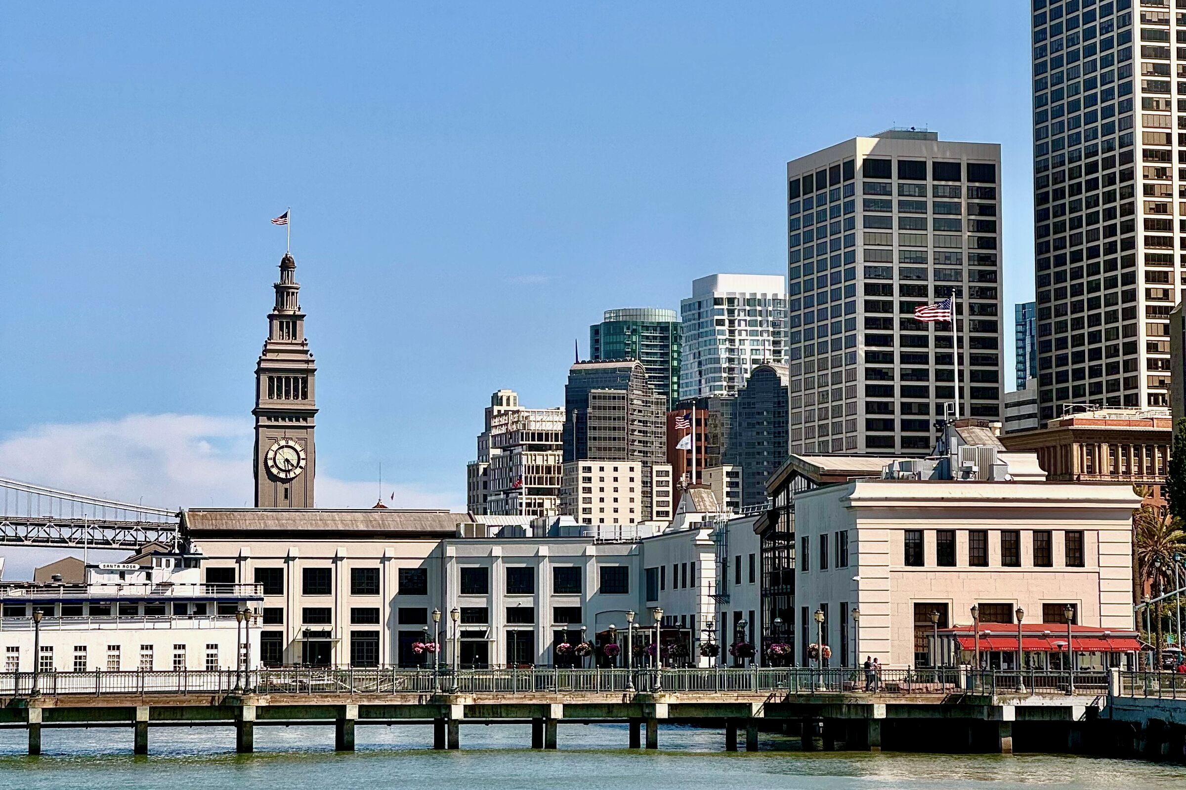 The Ferry Building with its clock tower and Embarcadero towers behind, viewed from the water
